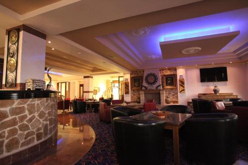 a hotel lobby with couches and a fireplace at Afkos Grammos Boutique Hotel Resort in Nestórion