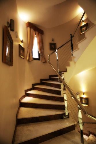 a set of stairs in a building with a window at Afkos Grammos Boutique Hotel Resort in Nestórion