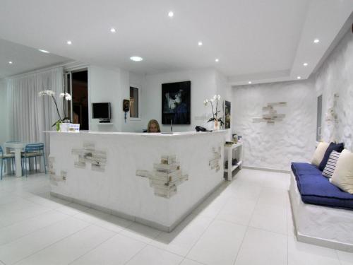 a large white bathroom with a marble counter top at Hotel Opera in Larnaka