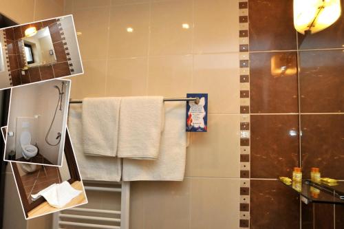 a bathroom with a shower and white towels at Family Hotel and Restaurant Plamena in Oreshak