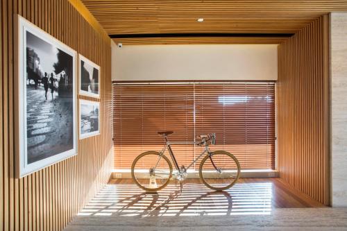 a bike parked in a room with a wall at JANEIRO Hotel in Rio de Janeiro