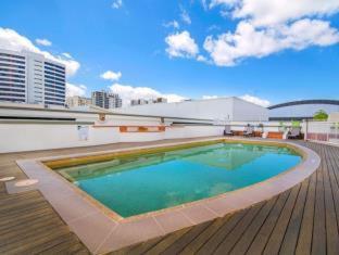 a large swimming pool on top of a building at Il Centro Apartment Hotel in Cairns