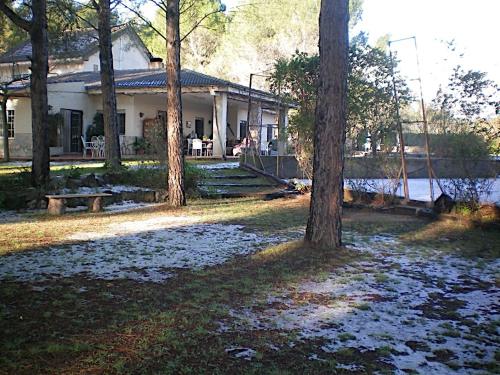 a white house with trees in front of it at Casa Rural Aire in Muro de Alcoy