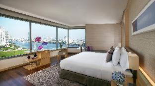 a large bedroom with a large bed and large windows at Avani Plus Riverside Bangkok Hotel in Bangkok