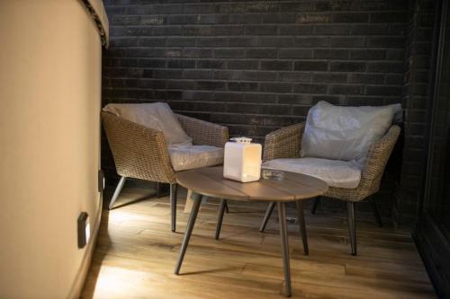 a table with two chairs and a candle on it at Pupin Palace Apartments in Novi Sad