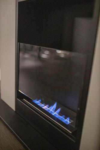 a microwave oven with blue lights inside of it at Pupin Palace Apartments in Novi Sad
