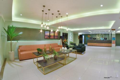 a living room with a couch and a table at Primme Hotel Aracaju in Aracaju