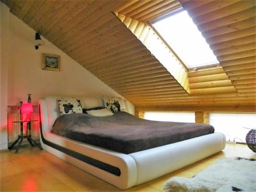 a large bed in a room with a large window at President Apartments in Vilnius