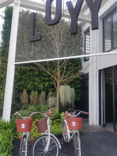 two bikes parked in front of a building at Loyy Hotel in Chiang Mai