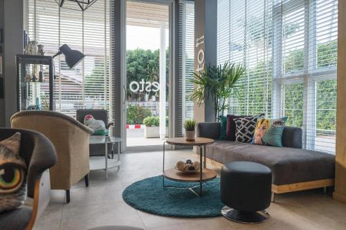 a living room with a couch and a table at The Bliss Ubon in Ubon Ratchathani