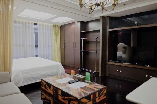 a hotel room with a bed and a tv at Ring Service Apartment 798 Art Zone in Beijing