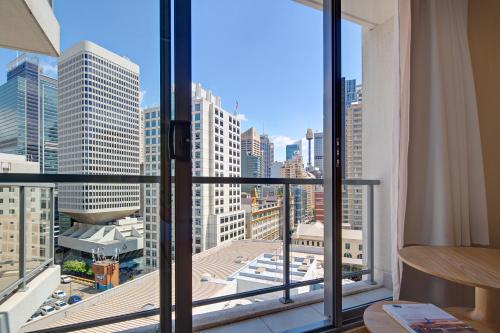 
a view from a window of a city with tall buildings at Zara Tower – Luxury Suites and Apartments in Sydney
