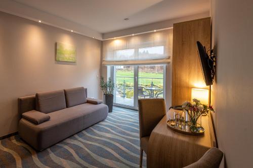 a living room with a couch and a table at Hotel Bardo in Bardo