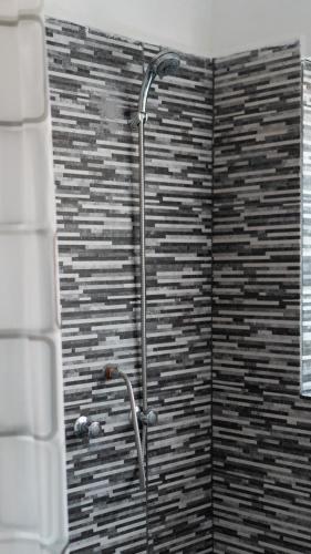 a shower in a bathroom with a brick wall at House in Cusco in Cusco