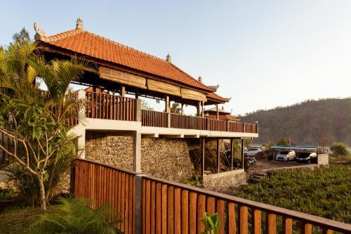a large building with a fence in front of it at Villa Jempana Kintamani in Kintamani