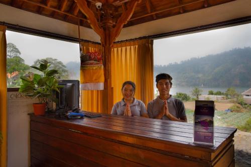 two people standing in a room with their ties at Villa Jempana Kintamani in Kintamani