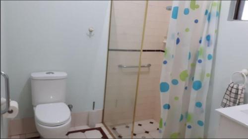 a bathroom with a shower with a toilet and a shower curtain at Beatrice in Perth