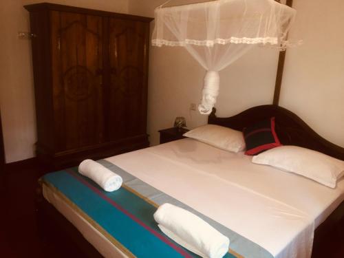 a bedroom with a bed with towels on it at Serendipity (Weligama) in Weligama