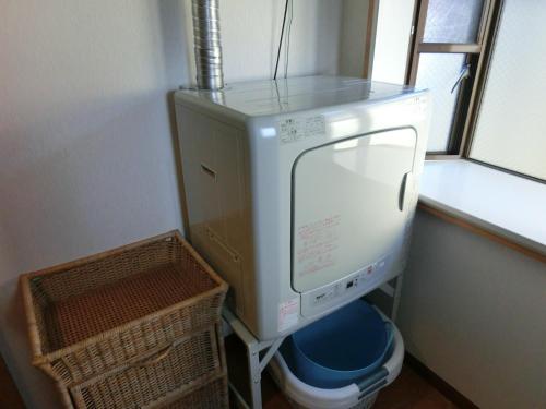 a washing machine in a room with a window at Mt Fuji Hostel Michael's in Fujiyoshida