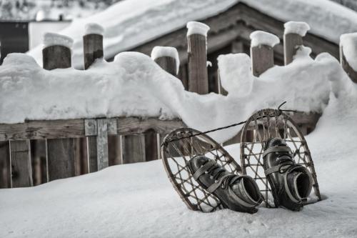 a pair of lights in the snow next to a fence at Hüttendorf Ladizium in Ladis
