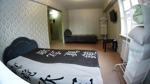 a bedroom with a bed with chinese writing on it at Apartments on Prospekt Dimitrova in Novosibirsk