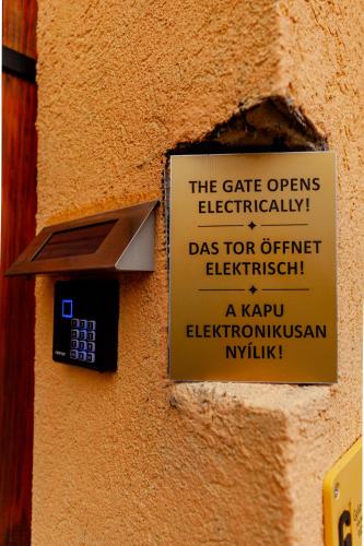 a sign on the side of a wall with a cell phone at King Arthur Panzió in Baja