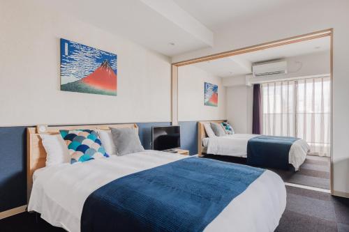 מיטה או מיטות בחדר ב-BON Condo Namba Nipponbashi