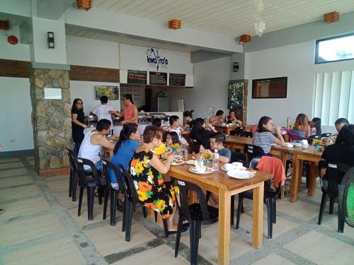 a group of people sitting at tables in a restaurant at Pacific Waves Inn (Annex) in Baler