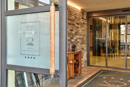 a window of a store with a sign on it at Hotel Miramonti in Schio