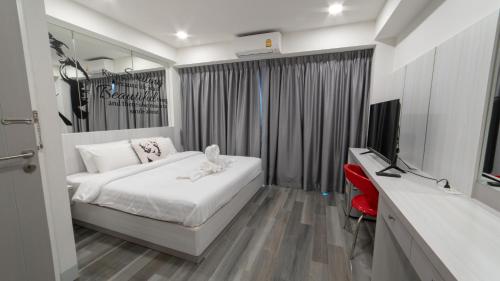 - une chambre avec un lit et une télévision dans l'établissement Frankie's Inn, à Jomtien Beach
