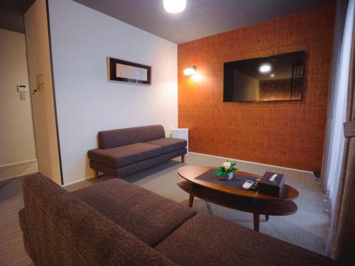 a living room with a couch and a table at GRAND BASE Hakata Sumiyoshi in Fukuoka