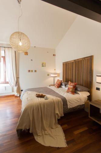 a bedroom with a large bed and a table at Duomo Luxury Apartment Orvieto in Orvieto