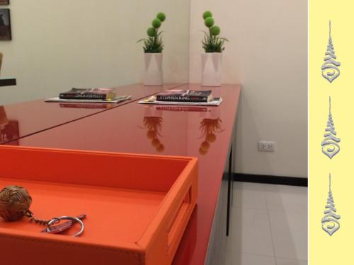 a table with books and plants on top of it at Apt S104 Kamala Regent in Kamala Beach