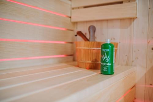 a green bottle sitting on a shelf in a sauna at Mountain Paradise & Wellness in Izvoare