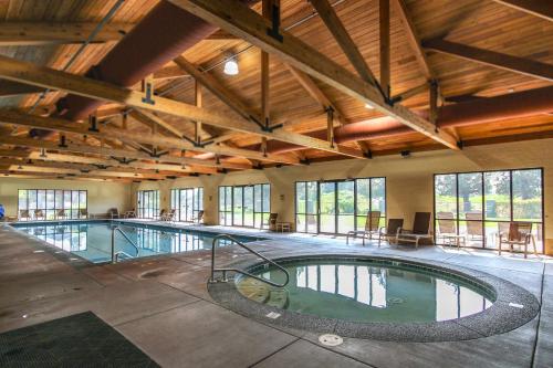 a large indoor swimming pool in a building with windows at Eagle Crest Family Retreat in Redmond