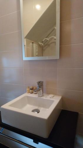 a bathroom with a white sink and a mirror at 10 The Kiln in Westport
