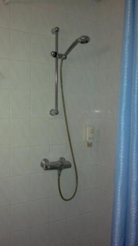 a shower with a hose in a bathroom at Transvaali 28 B&B in Kuressaare