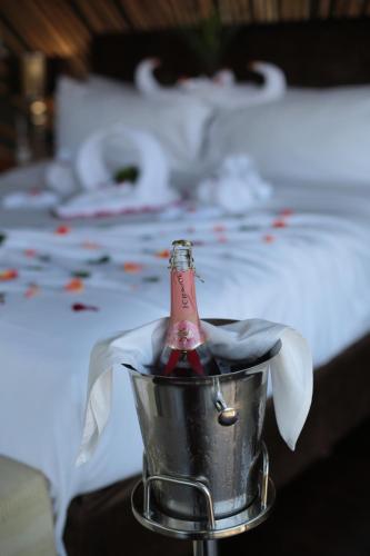 a champagne bottle in a bucket on a table at Palala Boutique Game Lodge and Spa in Tom Burke