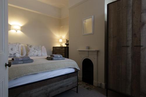 a bedroom with a bed with blue towels on it at William House in Chester