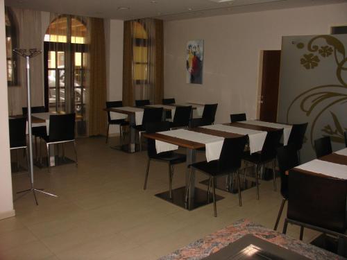 a restaurant with tables and chairs in a room at B&B Janežič in Ljubljana