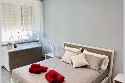 a bedroom with a bed with two red stuffed animals on it at Appartamento Moderno Soverato in Soverato Marina