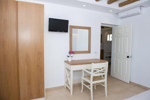a room with a table and a mirror and a door at Mastichari Bay Hotel in Mastichari