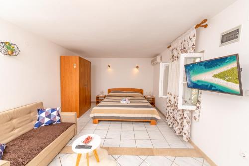Una pequeña habitación con una cama y un sofá. en Apartments Mate, en Bol