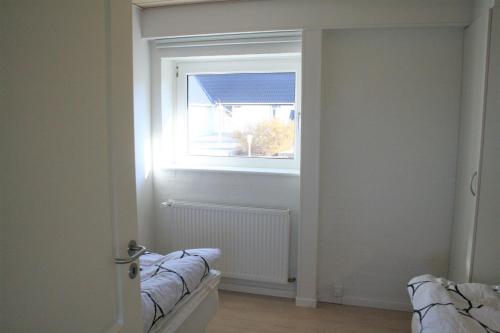 a window in a room with a radiator at Havrevang, Luksus ferielejligheder in Lønstrup