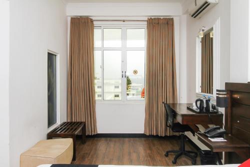 a living room with a desk and a window at Sasha Transit Hotel in Katunayake