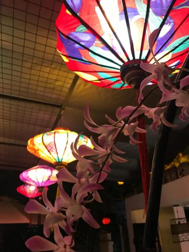 a bunch of lights and flowers hanging from a ceiling at Sunny Riverside Homestay in Hoi An