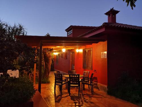 a patio with a table and chairs in front of a house at FINCA EL PEDREGAL in Valsequillo