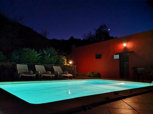 a swimming pool in a yard at night at FINCA EL PEDREGAL in Valsequillo