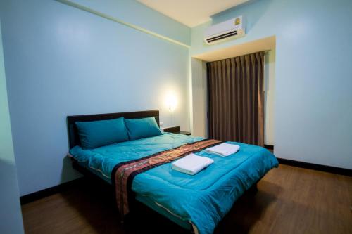 Una cama o camas en una habitación de จุฑาแมนชั่น