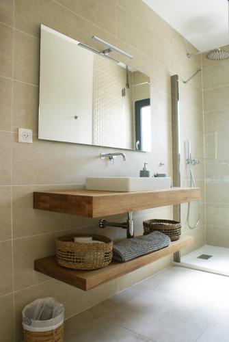 a bathroom with a sink and a mirror at La maison du Potier in Valras-Plage
